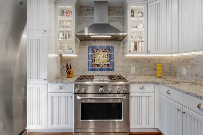 Alexandria Kitchen Remodel with Crystal Current countertops, Dal Tile ceramic backsplash and Dal Tile Nautical Blue deco tiles