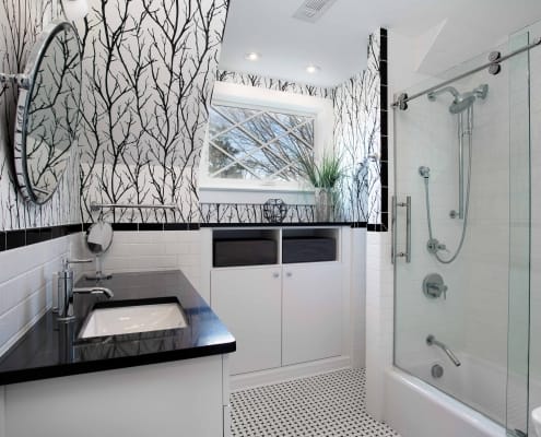 Alexandria Bathroom Remodel with custom black forest wallpaper and Kohler shower and tub fixtures with basketweave tile floor
