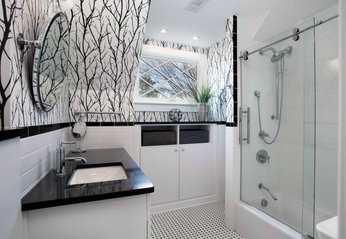 Alexandria Bathroom Remodel with custom black forest wallpaper and Kohler shower and tub fixtures with basketweave tile floor