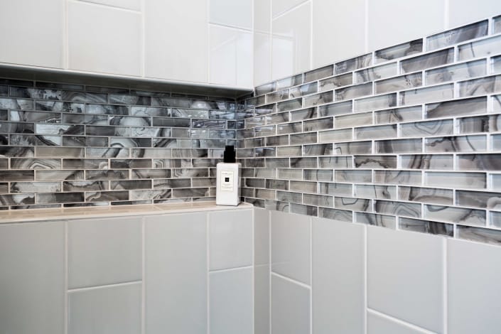 Shower installation, basement remodeling, Alexandria, VA with custom glass tile work in shower
