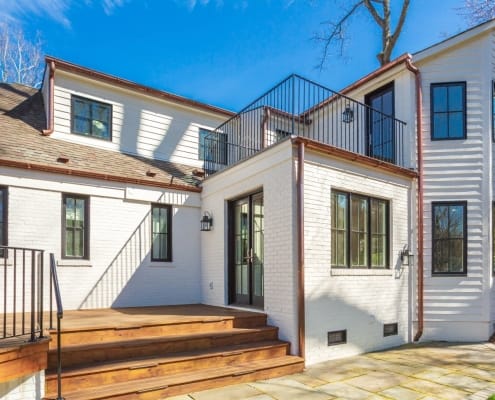 Arlington custom home addition with new decking and iron rail system and roof deck