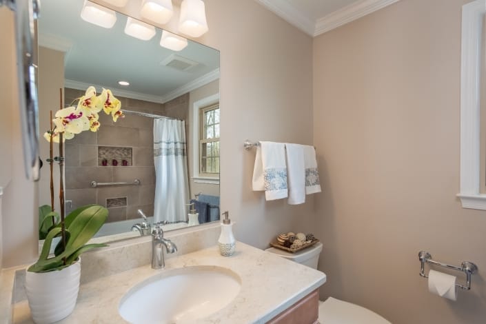 Woodbridge Hall Bathroom Remodel with Ceaserstone Taj Mahal vanity top and Sherwin Williams Cedar Key paint color
