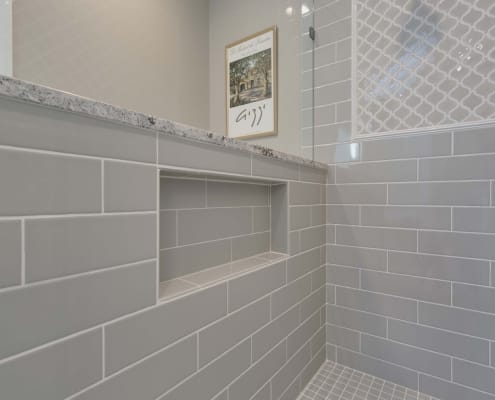 Fairfax Station Primary Bath Remodel using Dal Tile Elevare 4x16 glass tile for niche