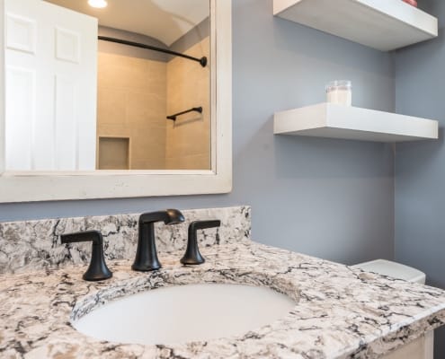 Bathroom remodel featuring granite countertop and oil rubbed bronze fixtures