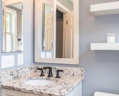 Rustic bathroom remodel in Arlington with custom vanity and mirror