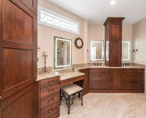Spacious traditional master bath remodel with Alder wood cabinets in a burnt copper stain