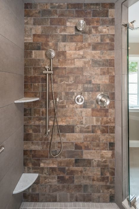 Custom master bath remodel with accent brick wall in shower stall and Moen fixtures