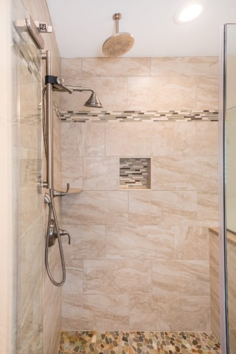 custom shower remodel fairfax station with recessed niche and pebble floor