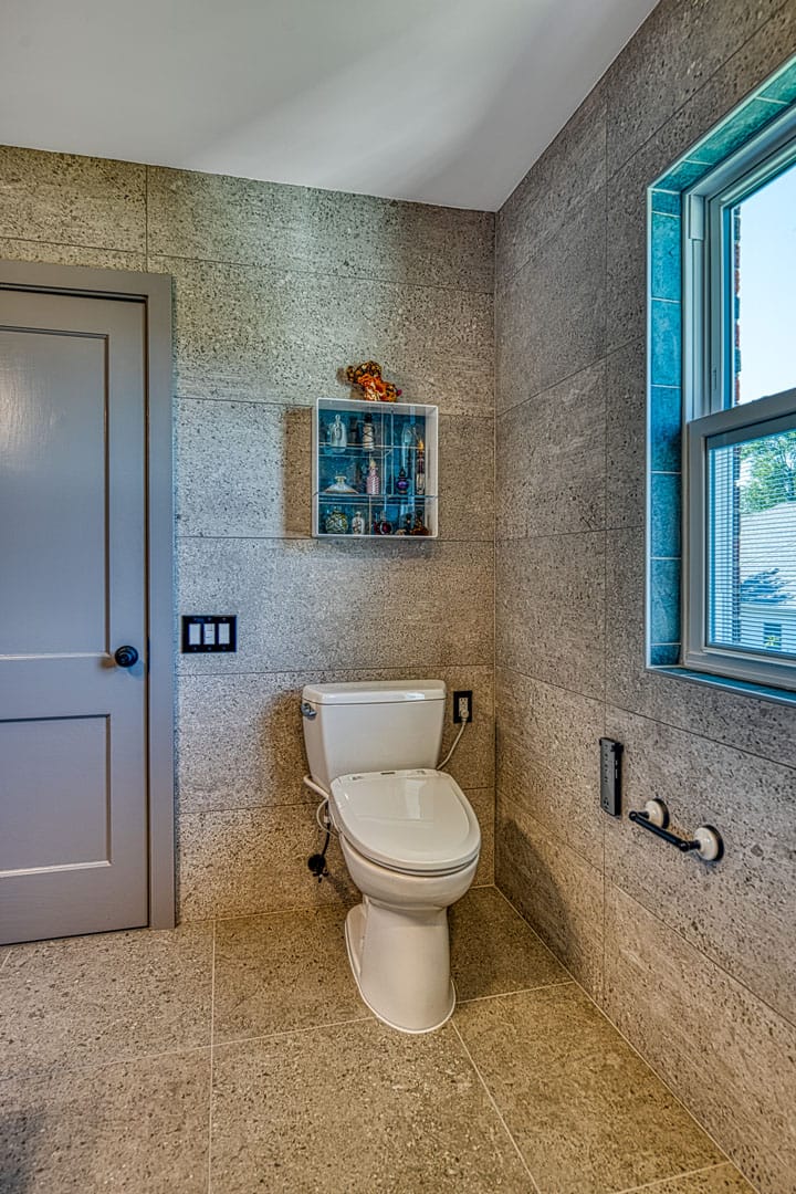 Bathroom remodel Arlington VA with stone tile and comfort height toilet with built in bidet