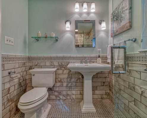 Falls Church bathroom remodel with Carrara marble chair rail and flooring