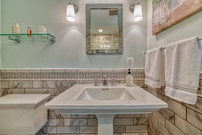 Falls Church bathroom remodel with Kohler Memoirs pedestal sink and Carrara marble basketweave backsplash