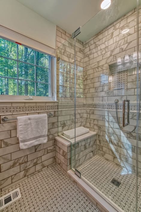 Glass shower in Falls Church bathroom remodel featuring Carrara marble