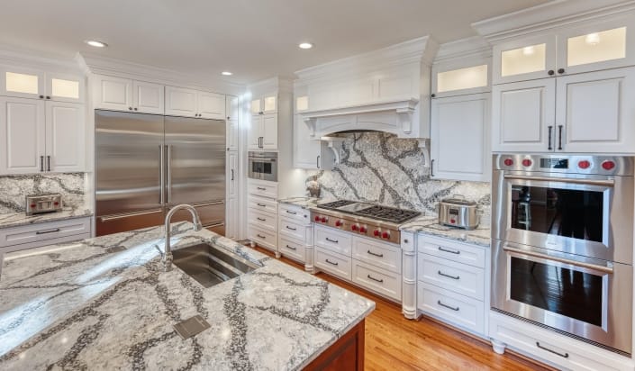 Kitchen Remodel in Haymarket VA features quartz countertops and back splash white and gray with dark grey veining
