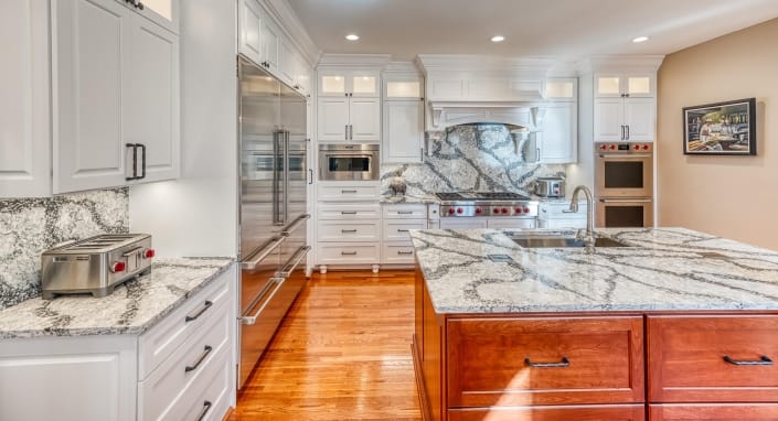 Haymarket Kitchen Remodel with white cabinets, stainless steel appliance and cherry cabinets