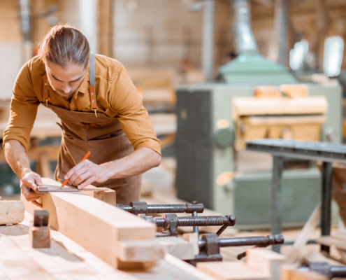 Carpenter working with a wood in the workshop