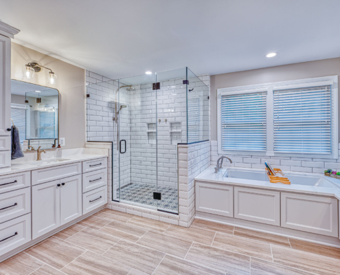 spacious white bathroom with light tile flooring