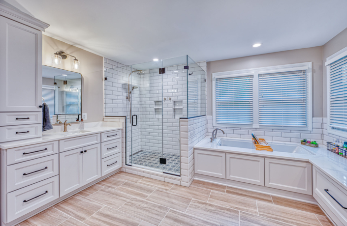 spacious white bathroom with light tile flooring