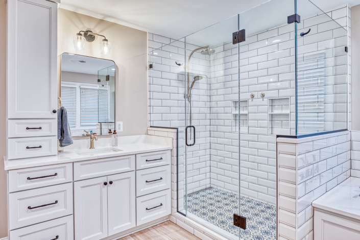 white vanity and custom shower stall with patterned shower floor