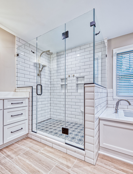 white vanity and custom shower stall with patterned shower floor