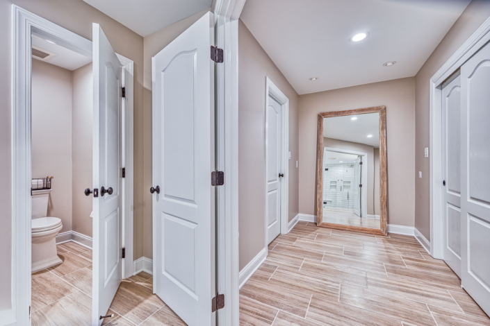 expansive bathroom remodel includes water closet and large walk in clothes closet.