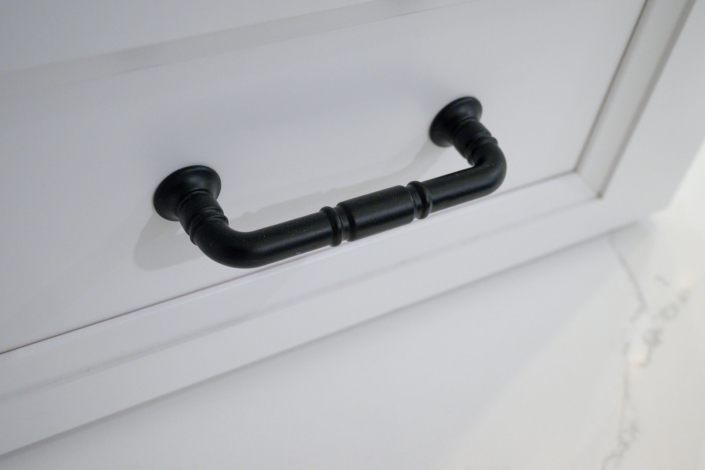 close up photo of drawer pulls on cabinet in newly remodeled bathroom