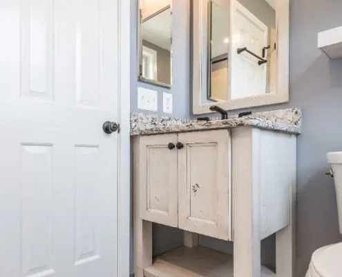  Farmhouse style bathroom remodel with wood look tile flooring and rustic vanity in Arlington, VA 